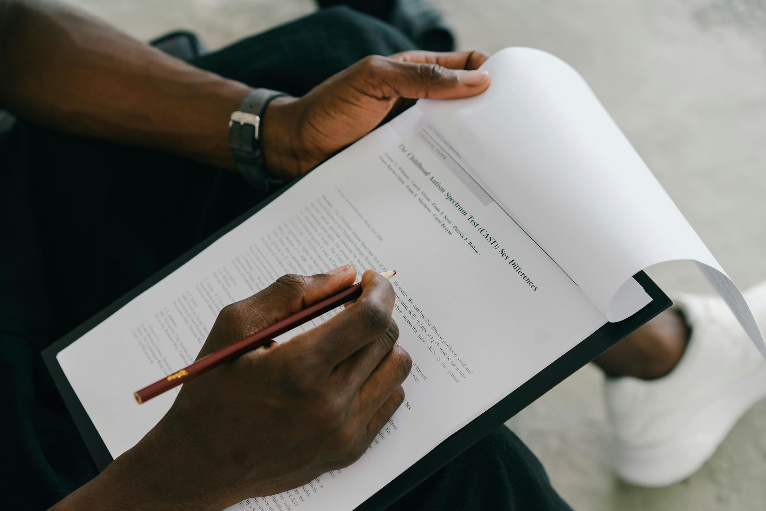 Professional analyzing and reviewing assessment results with notes, highlighting workplace assessment strategy and decision-making - Curiate Group